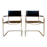 Pair of vintage chrome and black faux leather armchairs