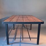 Vintage modernist coffee table in teak and black metal.