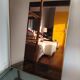 Vintage mirror in gilded brass and smoked glass. circa 1970