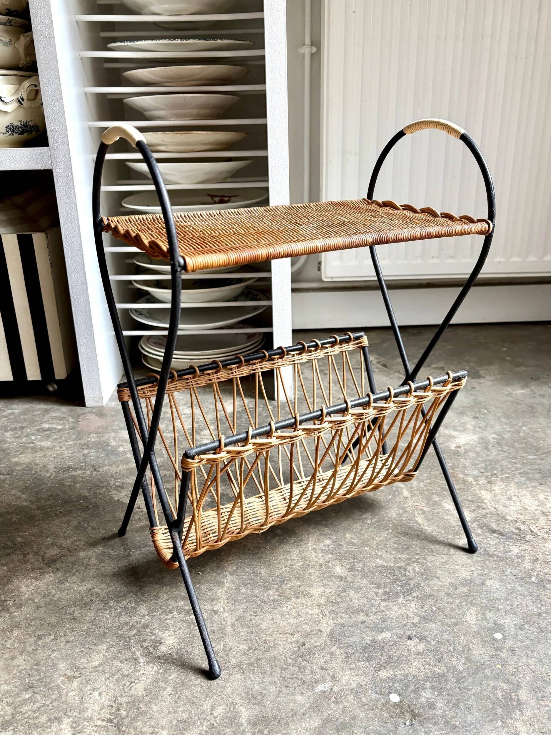 Black metal and woven wicker magazine rack