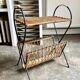Black metal and woven wicker magazine rack