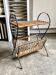 Black metal and woven wicker magazine rack