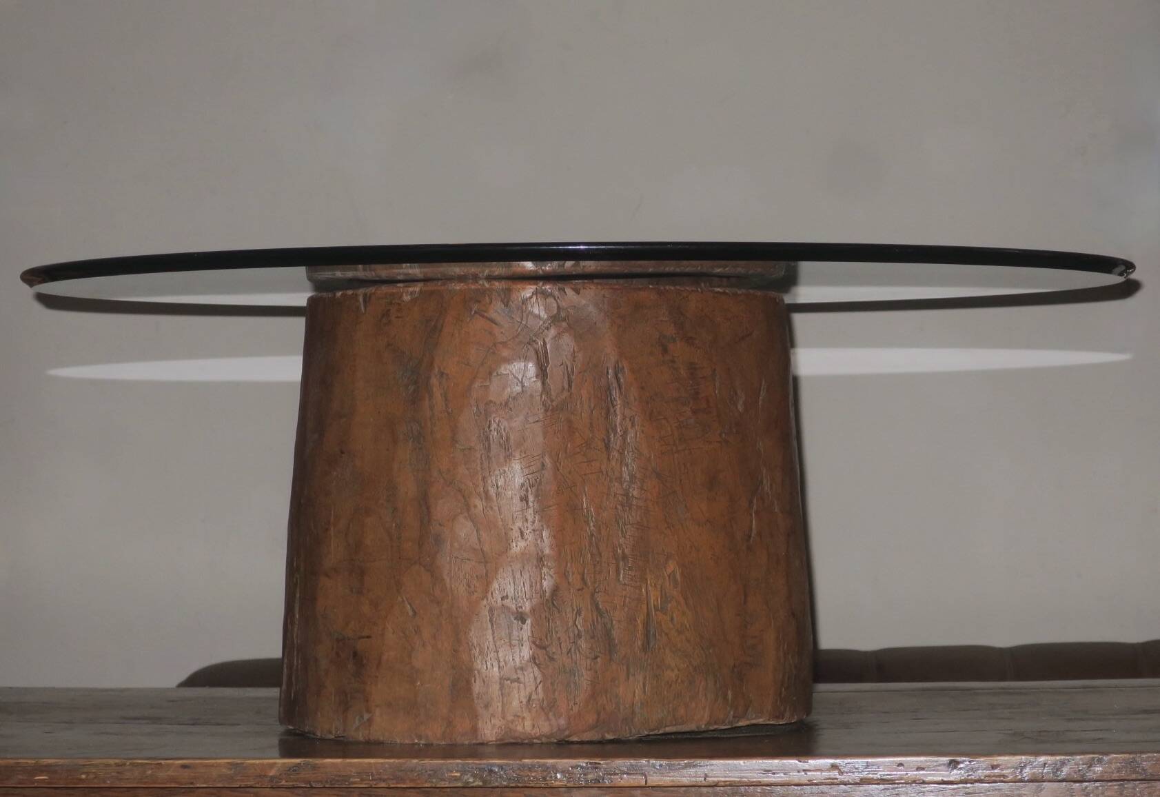 Carved antique tree stump coffee table with circular glass top