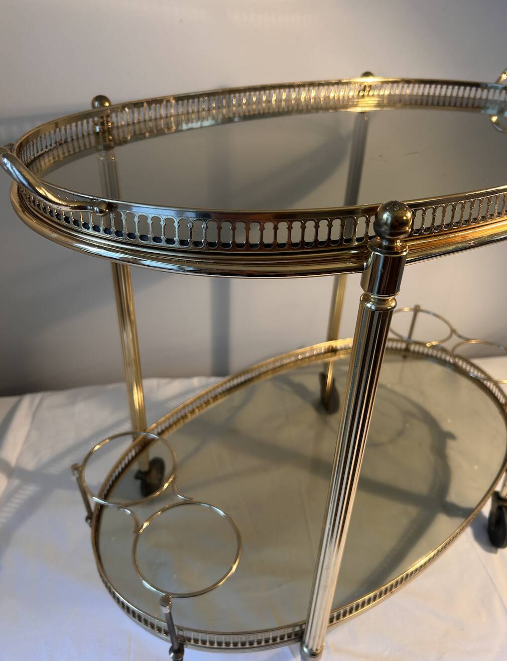 Neoclassical bar cart in gilded brass and smoked glass