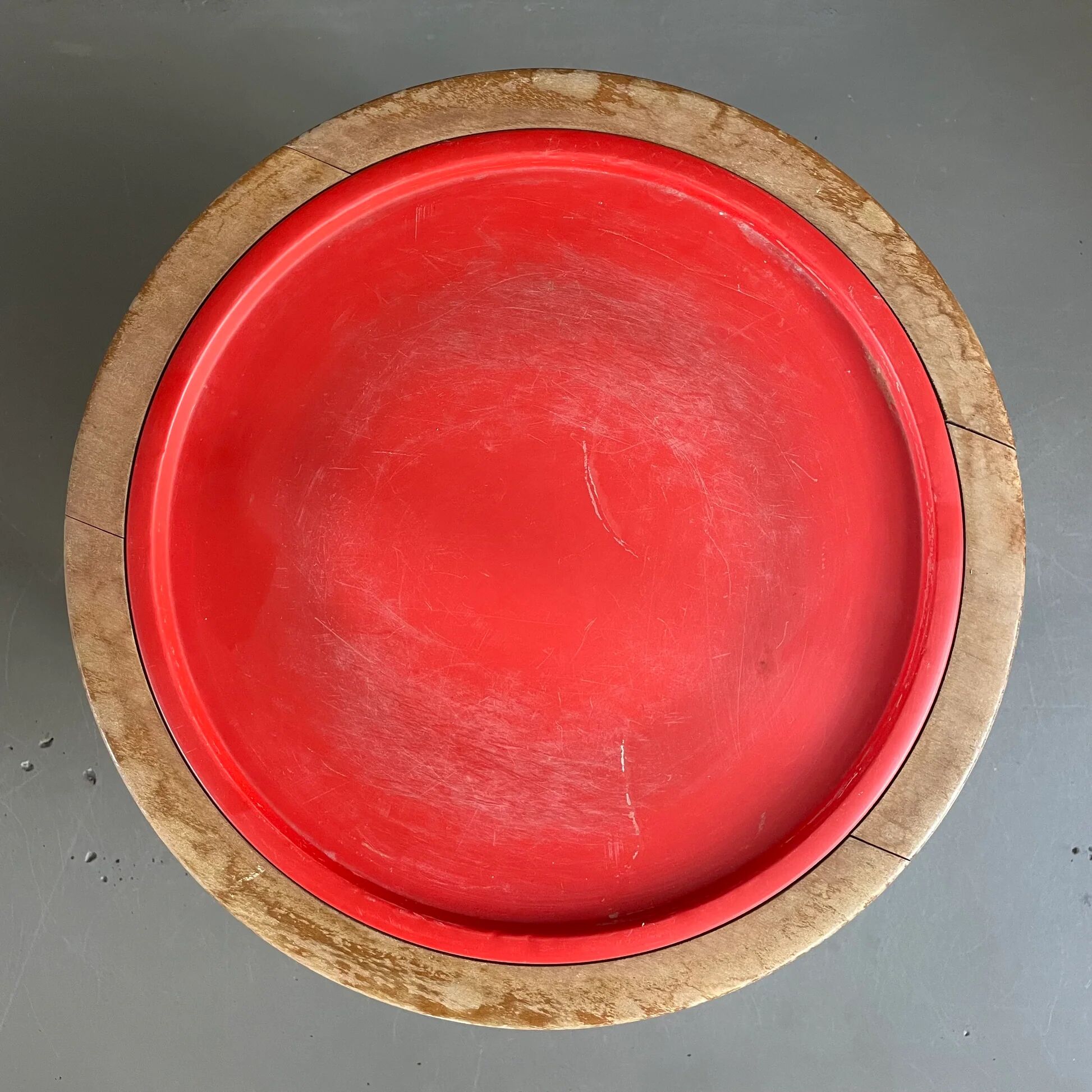 Wooden and red plastic compasses plant stand.