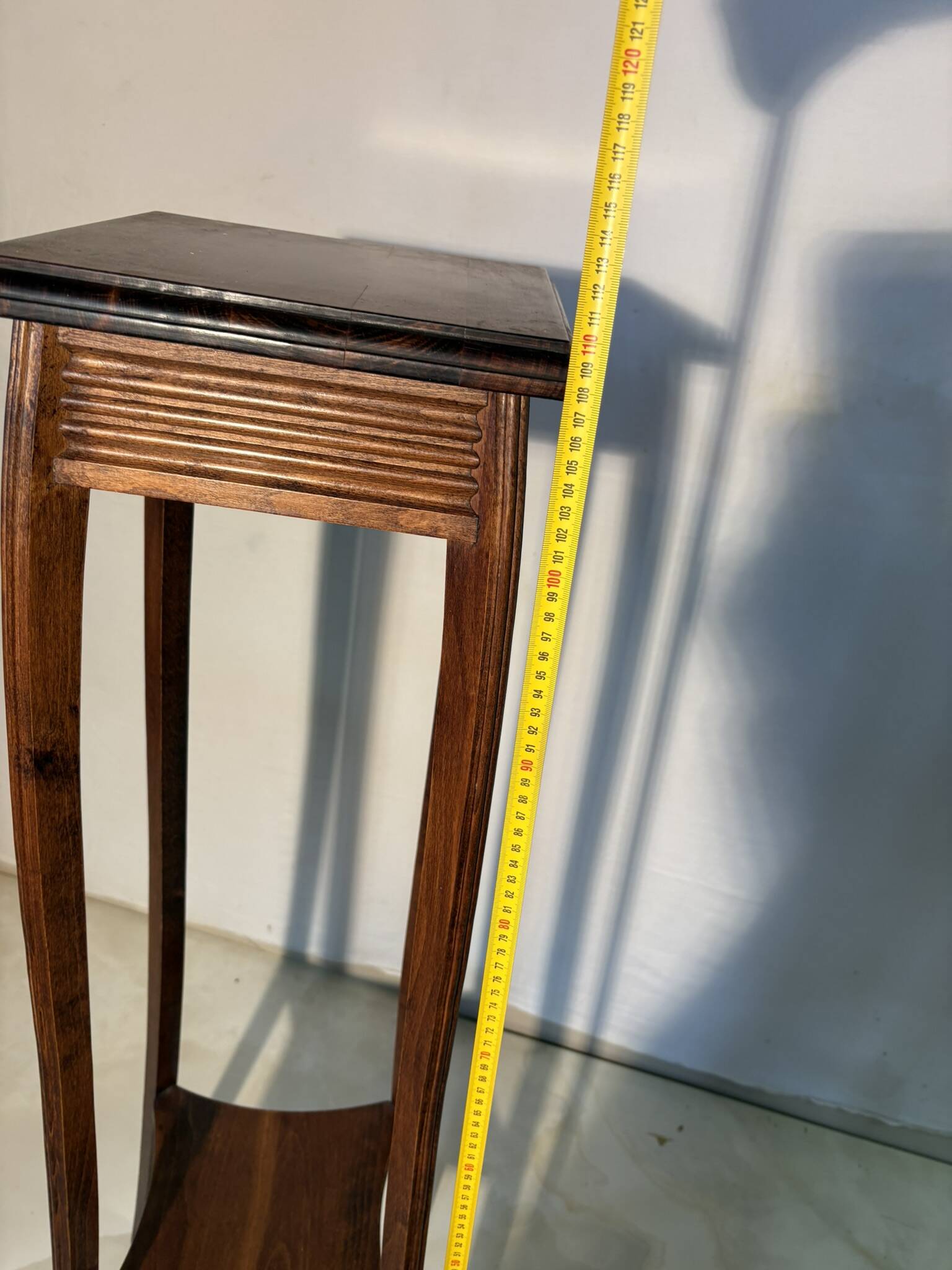 Vintage dark wood side table with curved base