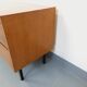 Small vintage Scandinavian sideboard in modernist style made of light oak wood.