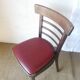 Set of 19 vintage wooden bistro chairs with red faux leather.