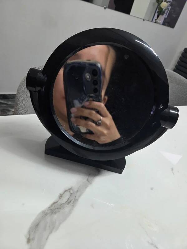 Vintage round pivoting mirror in black, retro style from the 70s/80s.