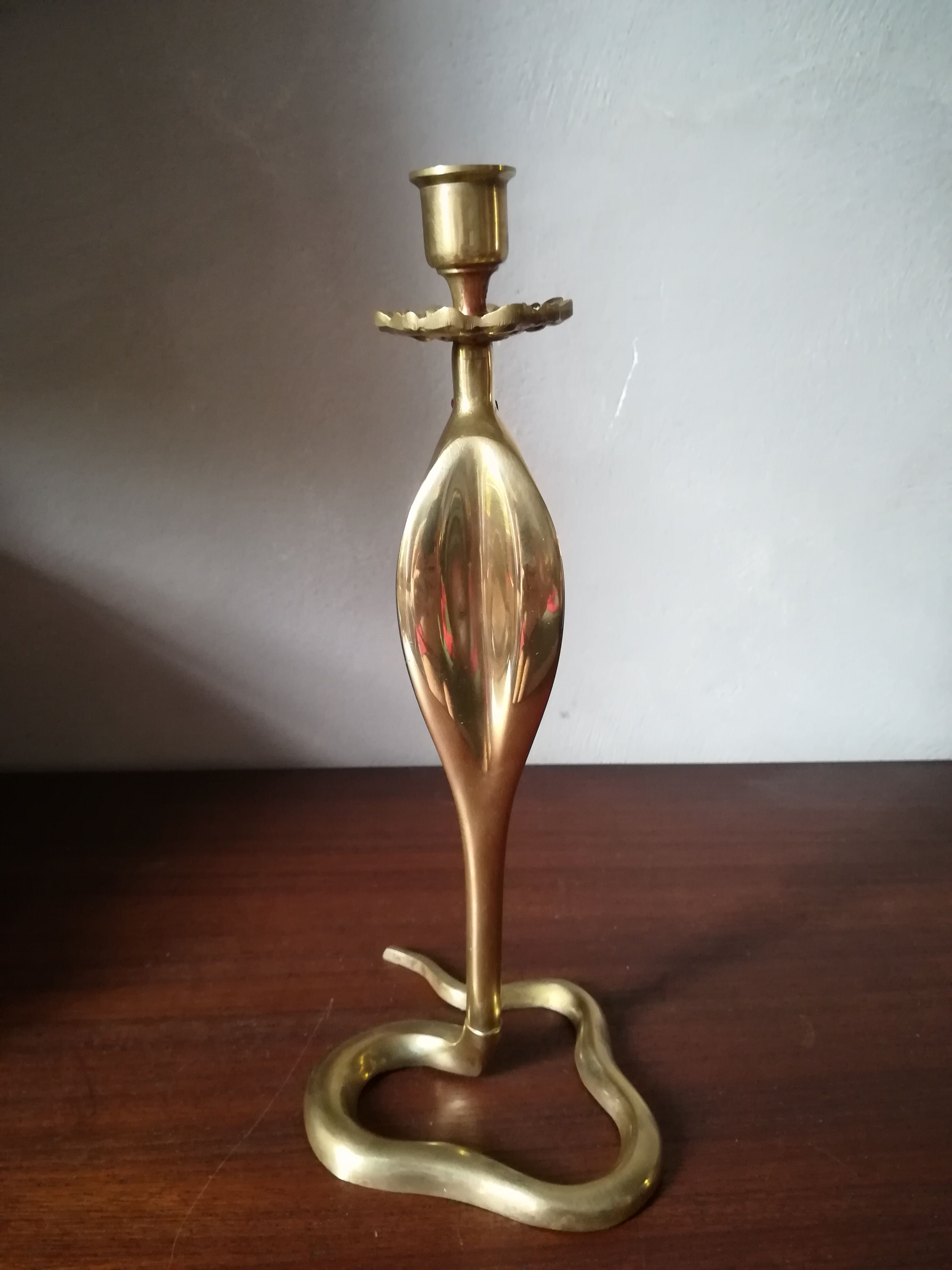 Candlestick mounted on brass cobra
