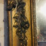 Old mirror with gilded leaves and flowers carved on top of it 1800s