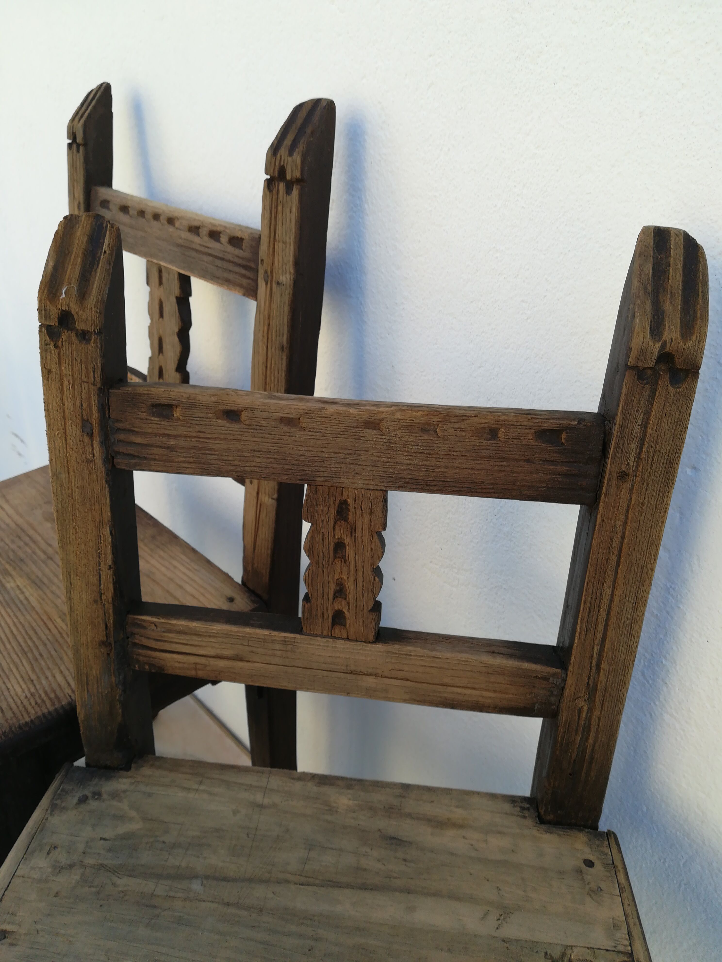 Pair of ethnic crude wooden chairs