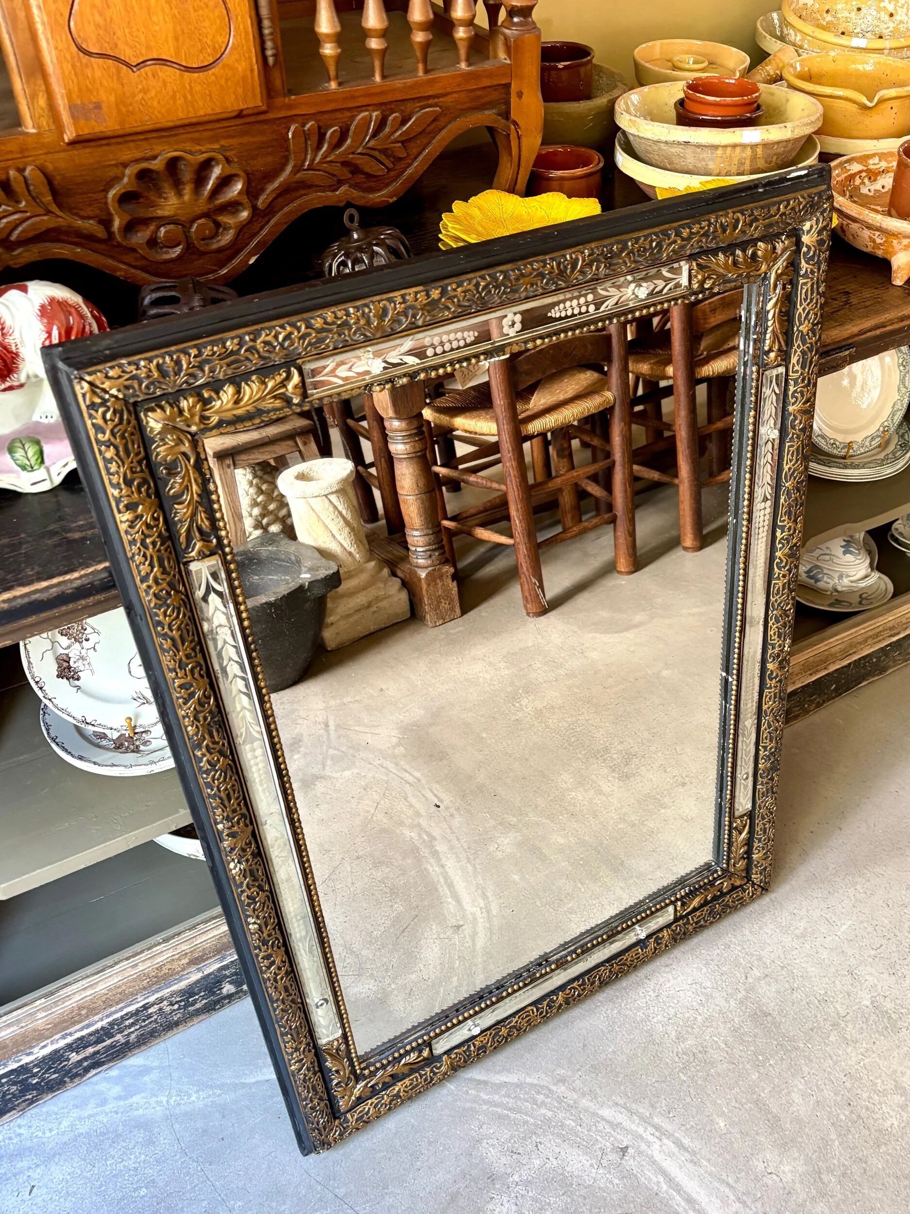 Rectangular Napoleon III mirror in moulded black and gold wood with engraved mirror decoration.