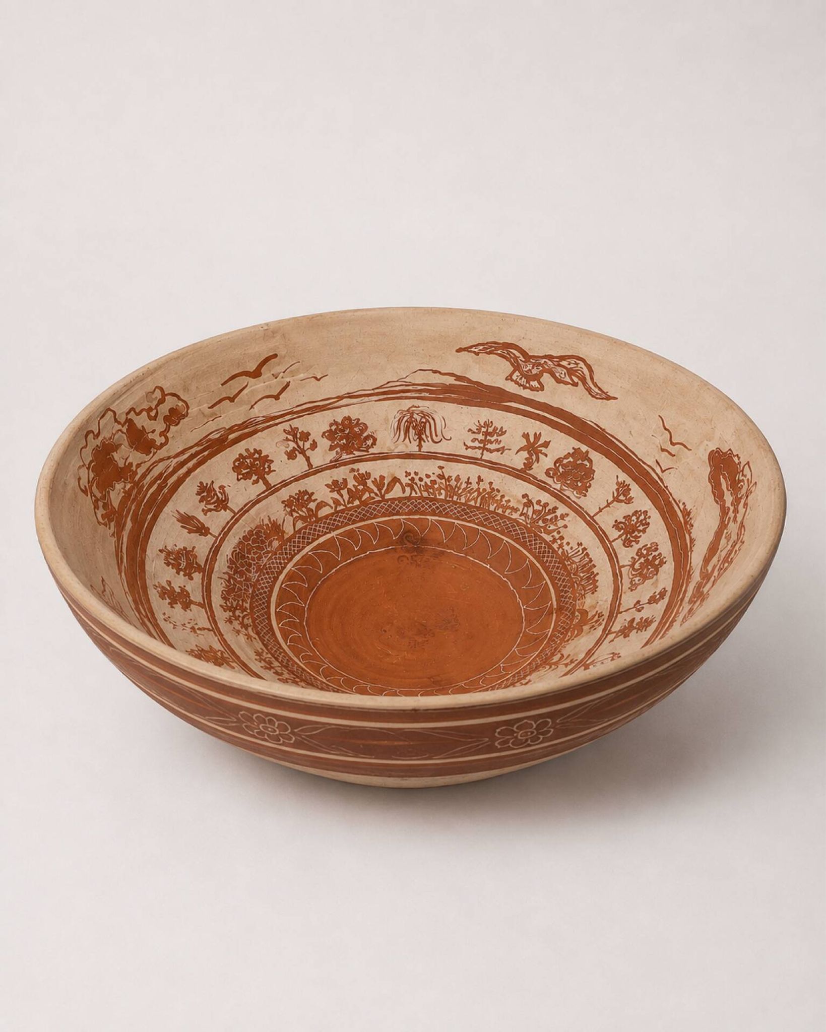 Large shallow terracotta dish decorated with birds, 20th century.