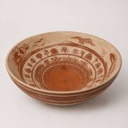 Large shallow terracotta dish decorated with birds, 20th century.