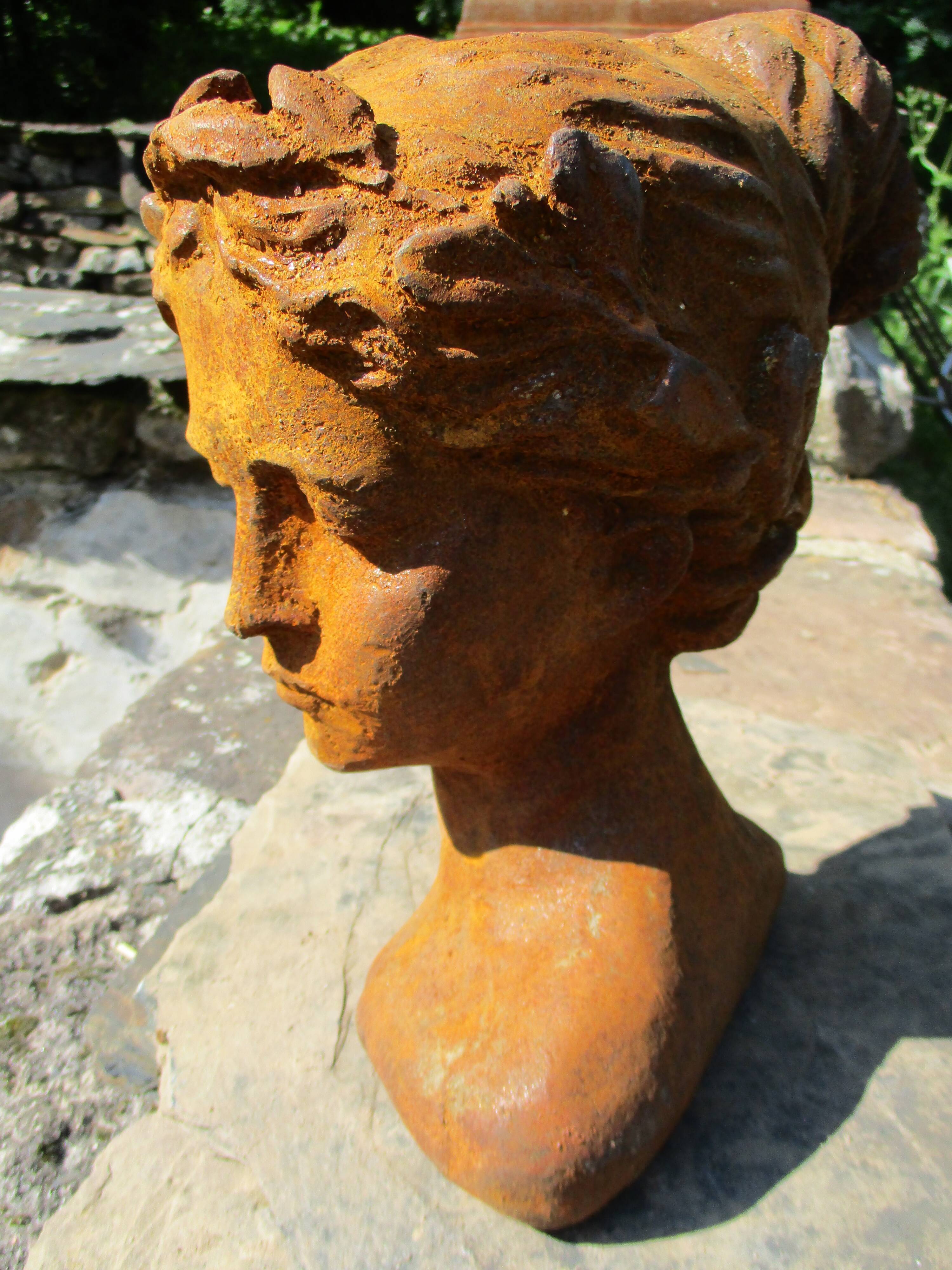 Cast iron sculpture of a woman.