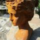 Cast iron sculpture of a woman.