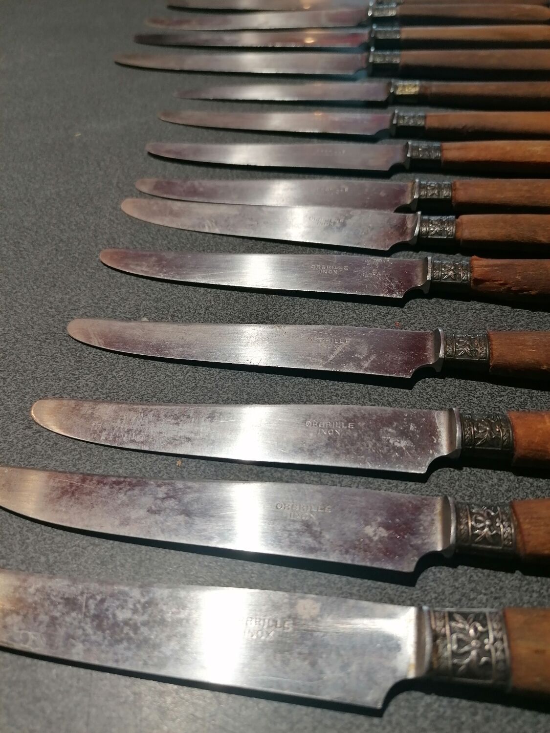 Old table knives and dessert knives, wooden handles, stainless steel blades