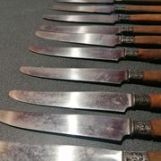 Old table knives and dessert knives, wooden handles, stainless steel blades