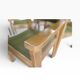 Vintage wooden chair with olive green seat and armrests.