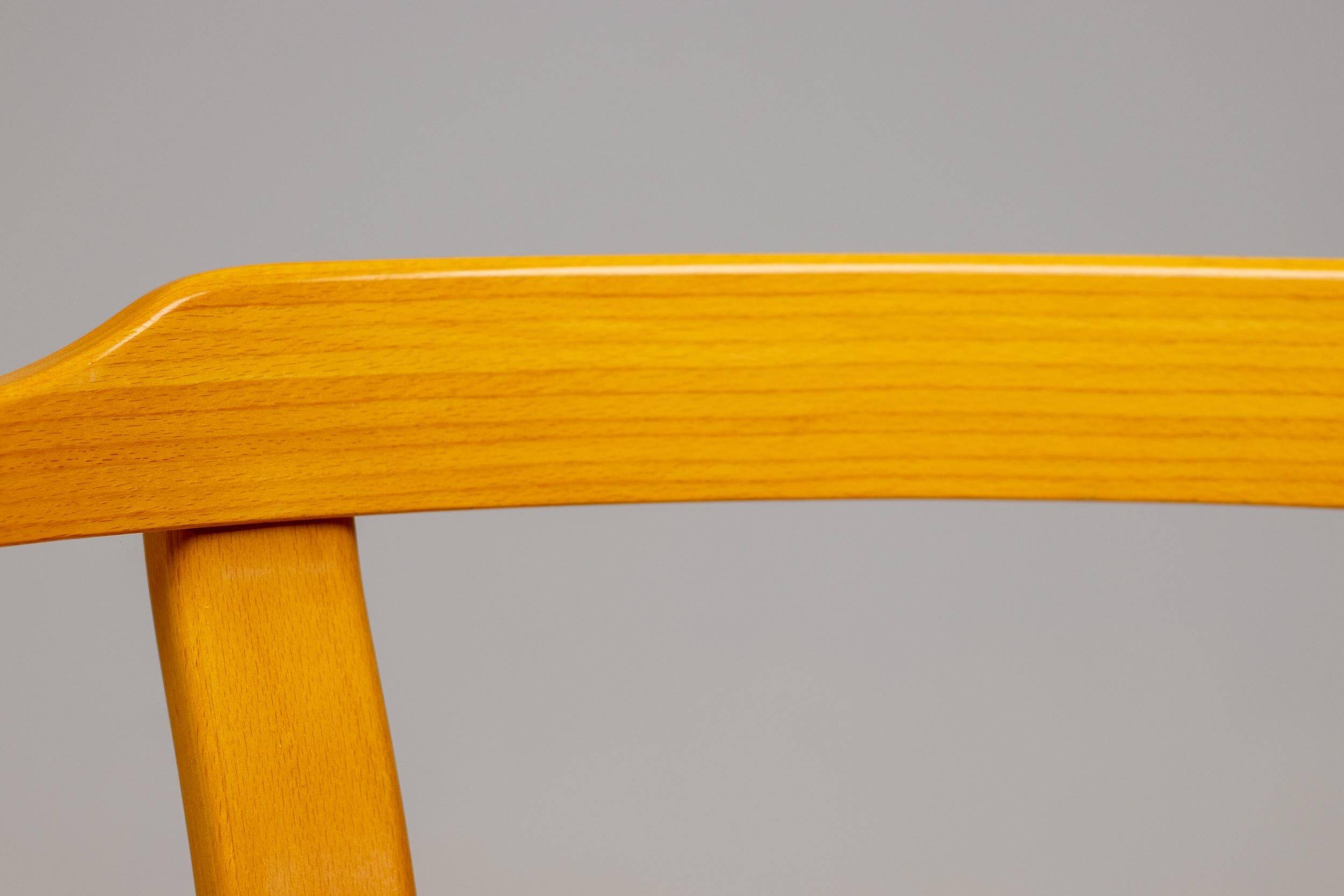 Stackable chairs in curved beech.