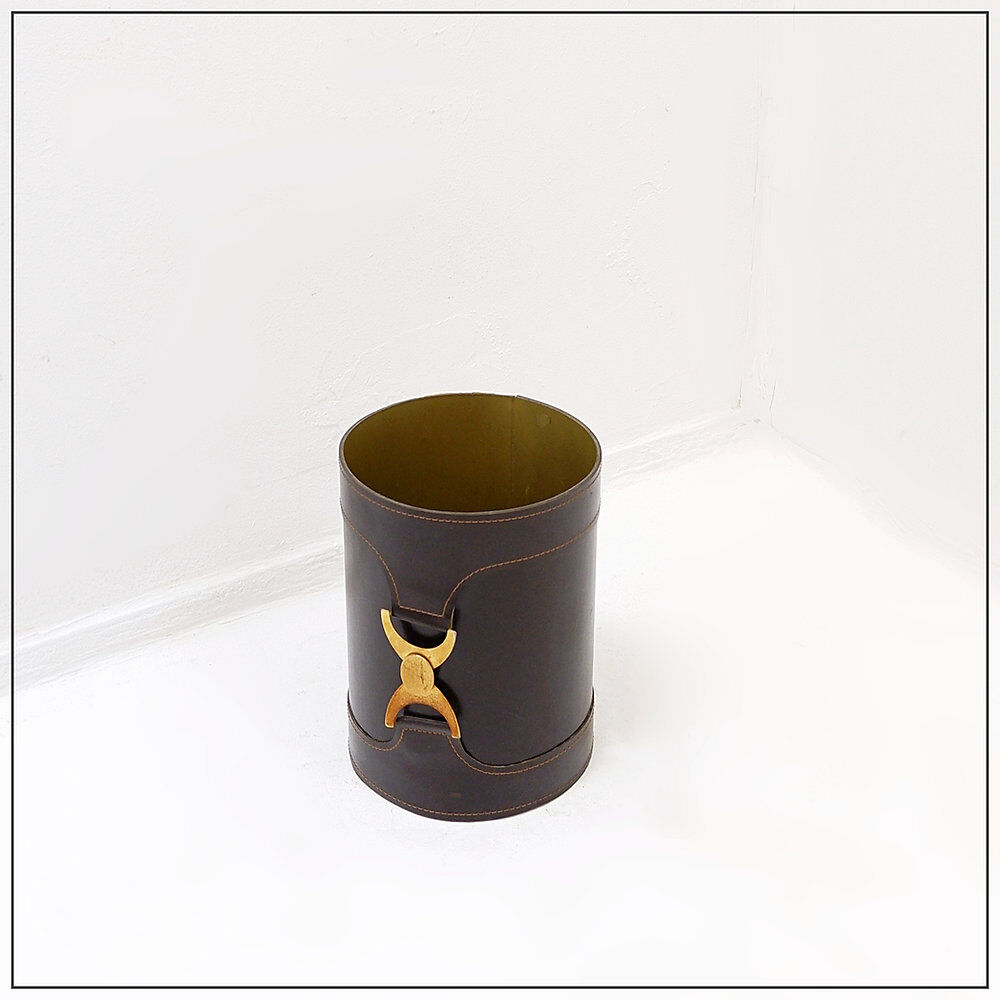 Brown leather wastepaper basket with decorative gold metal buckle.