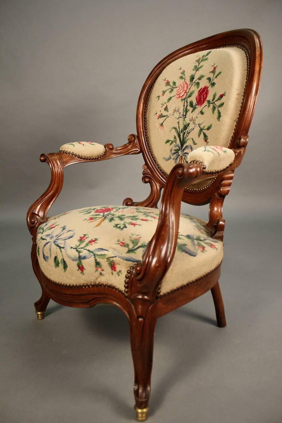 Pair of Louis Philippe armchairs with petit point upholstery.