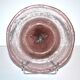 Antique plate in pink bubbled blown glass