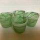 Four green glass paste candle holders