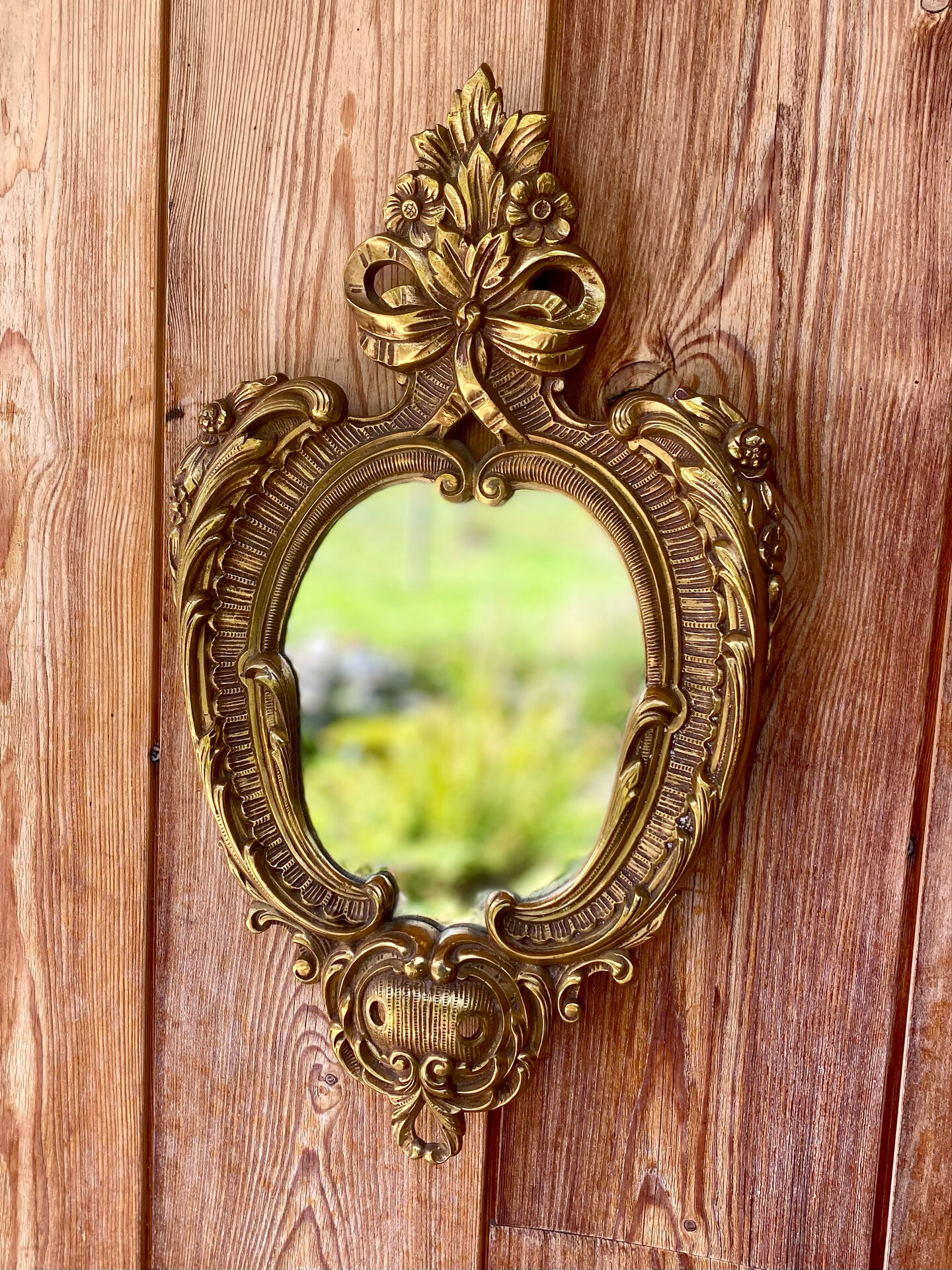 oval decorative wall mirror in Louis XV style