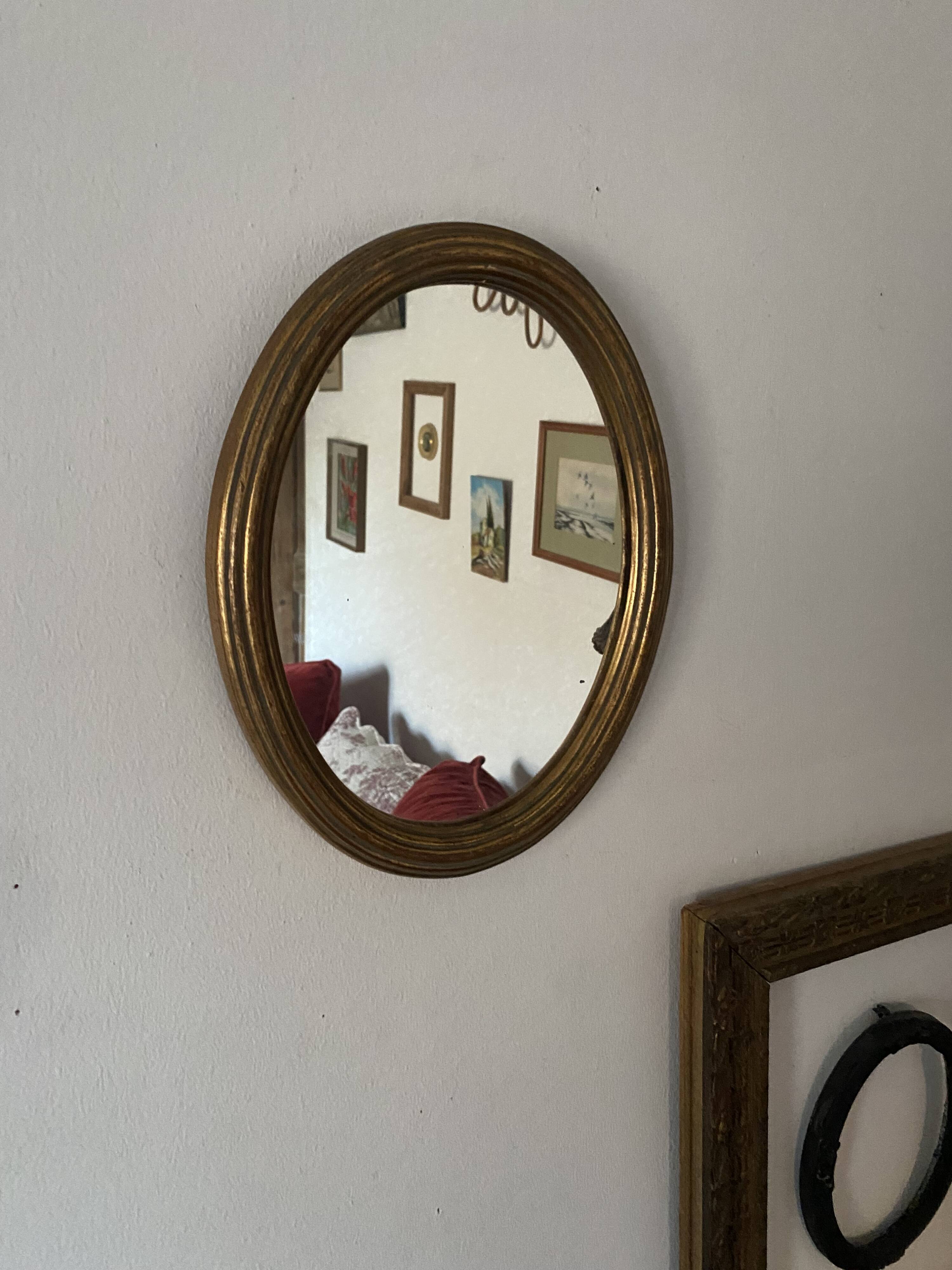 Classic oval mirror in gilded wood.