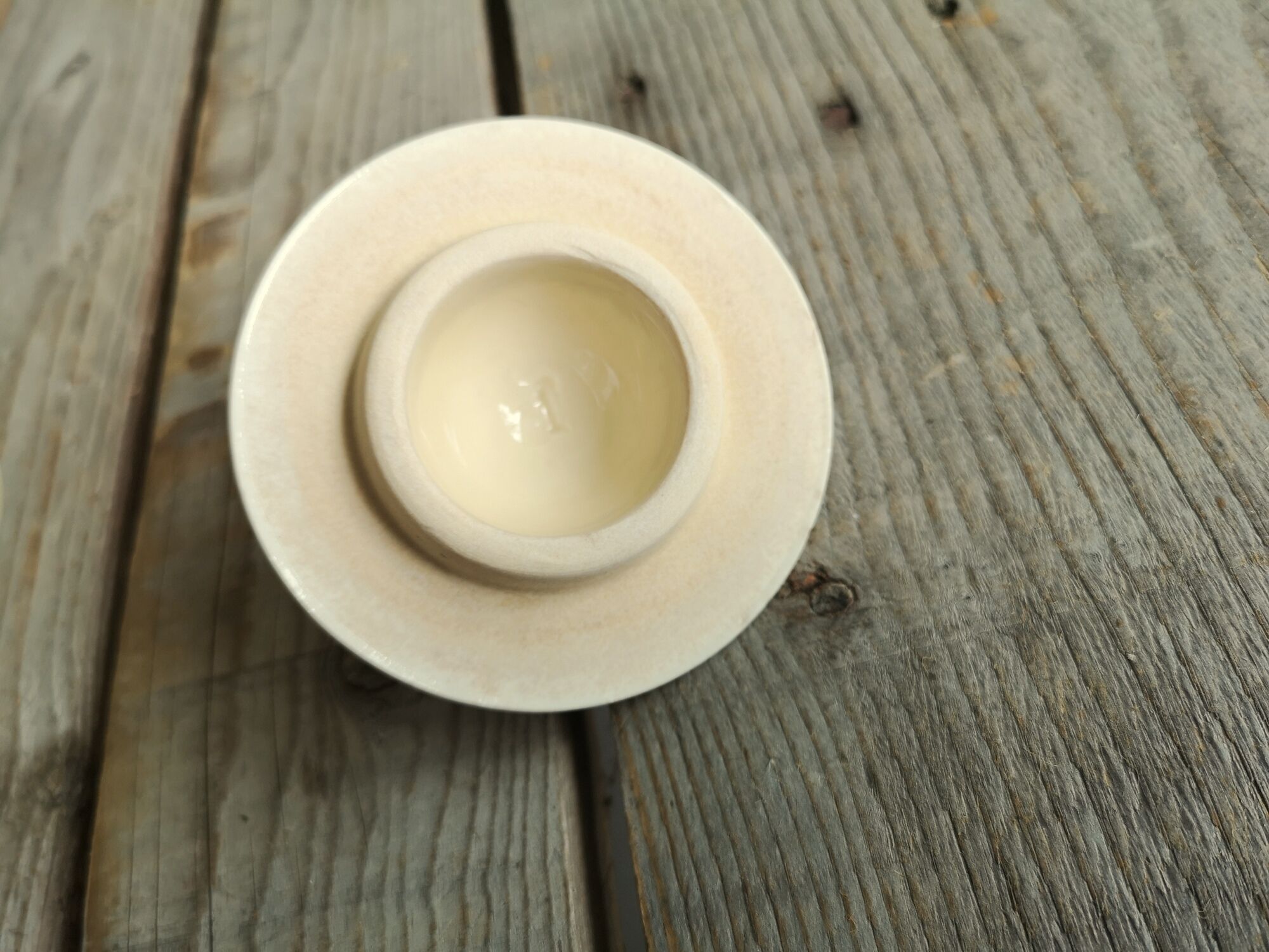 Little ancient teapot in ceramics color cream