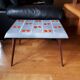 Small 1960s enamelled table, spindle legs, signed jd.