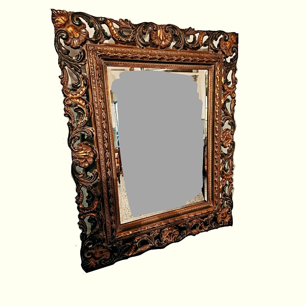 Bevelled mirror and carved wood