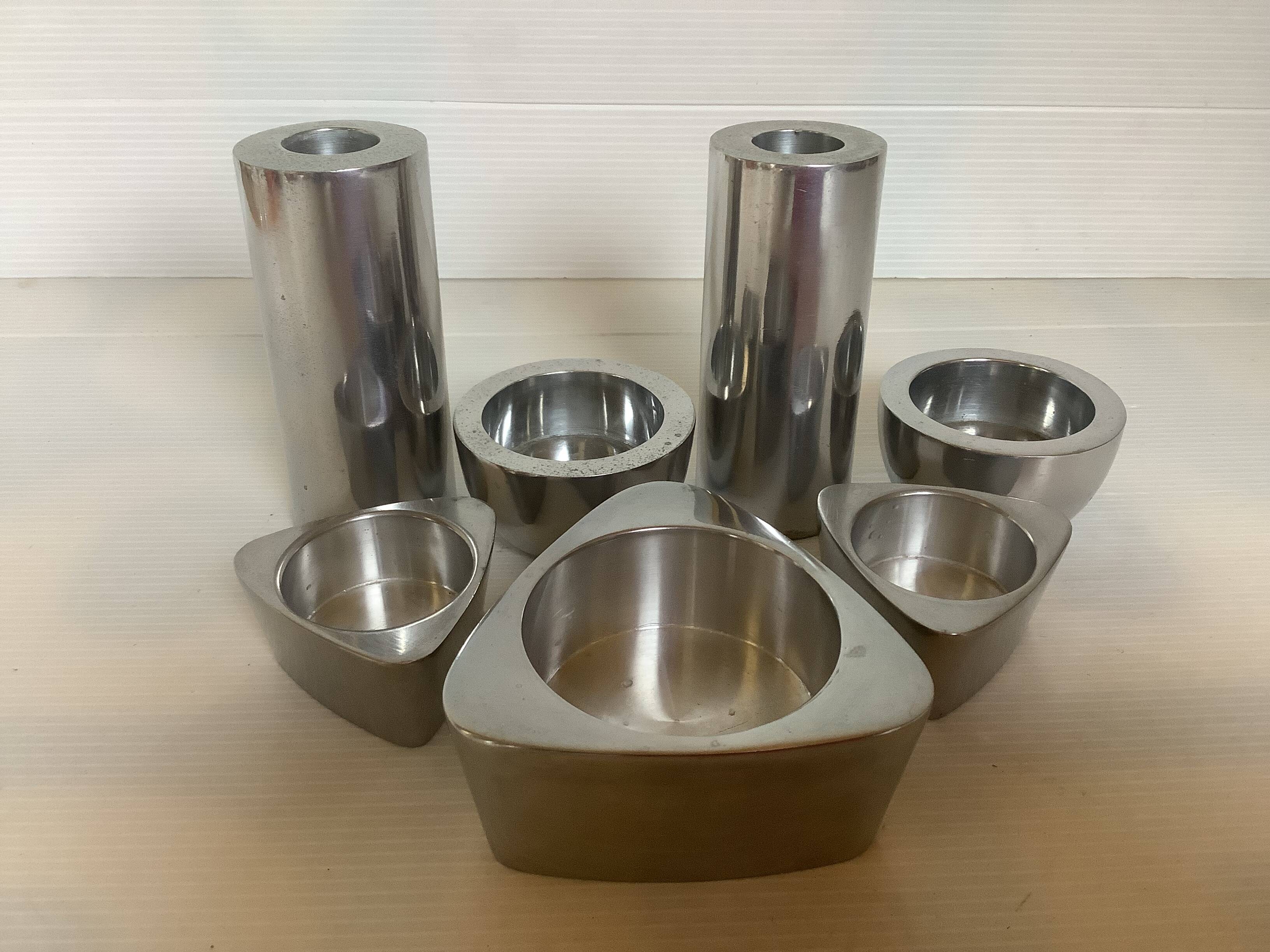 Seven different metal candle holders