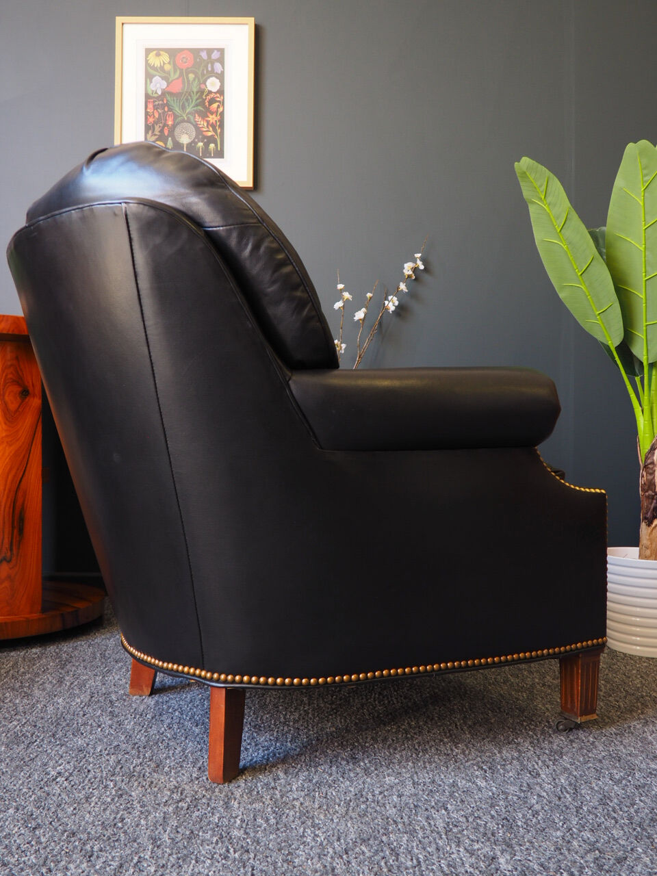Chesterfield style leather armchair & footstool by Hancock & Moore