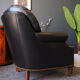 Chesterfield style leather armchair & footstool by Hancock & Moore