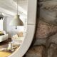 Large Space Age wall mirror in white-patinated wood. France, 1970s