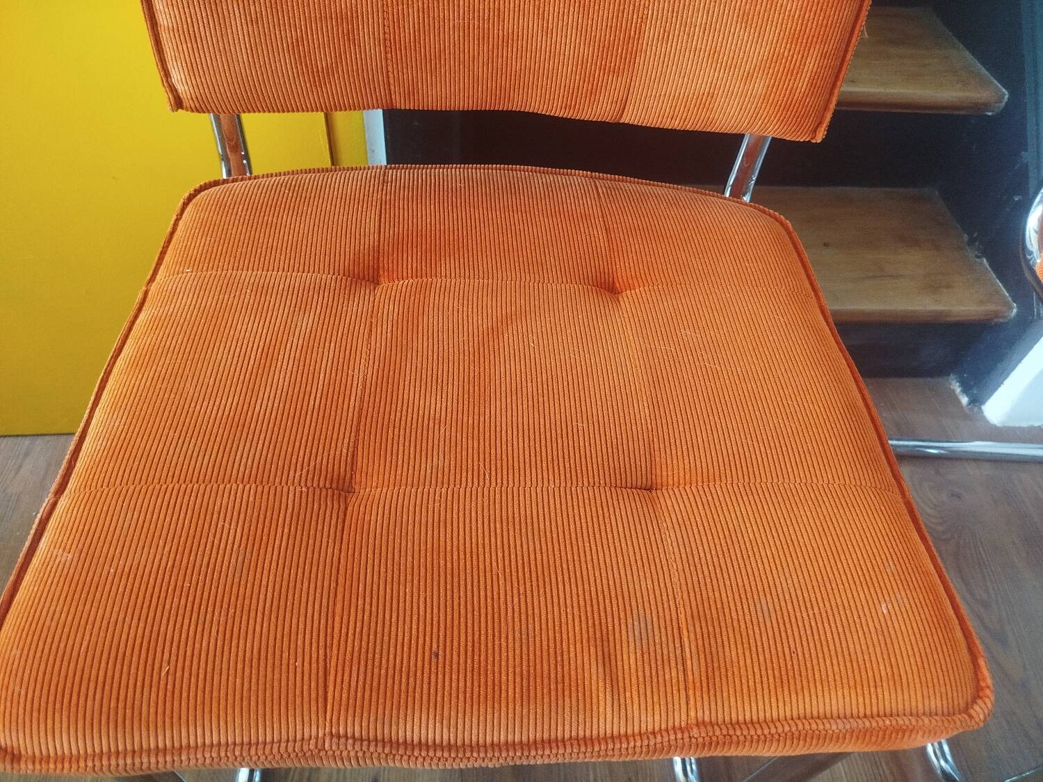 Pair of vintage cantilever chairs in chrome and orange corduroy.