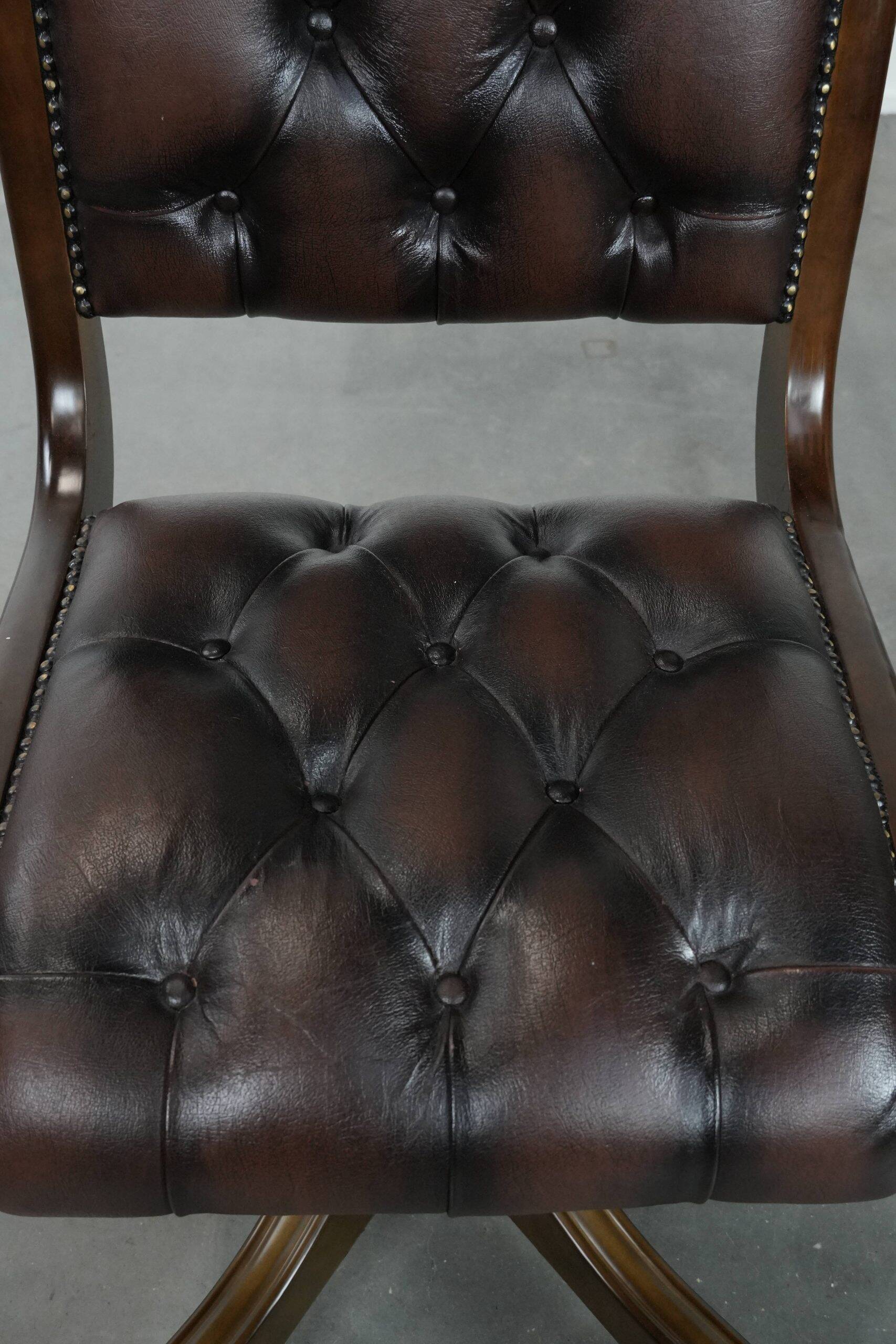 Chesterfield office chair in English style made of cow leather and wood.