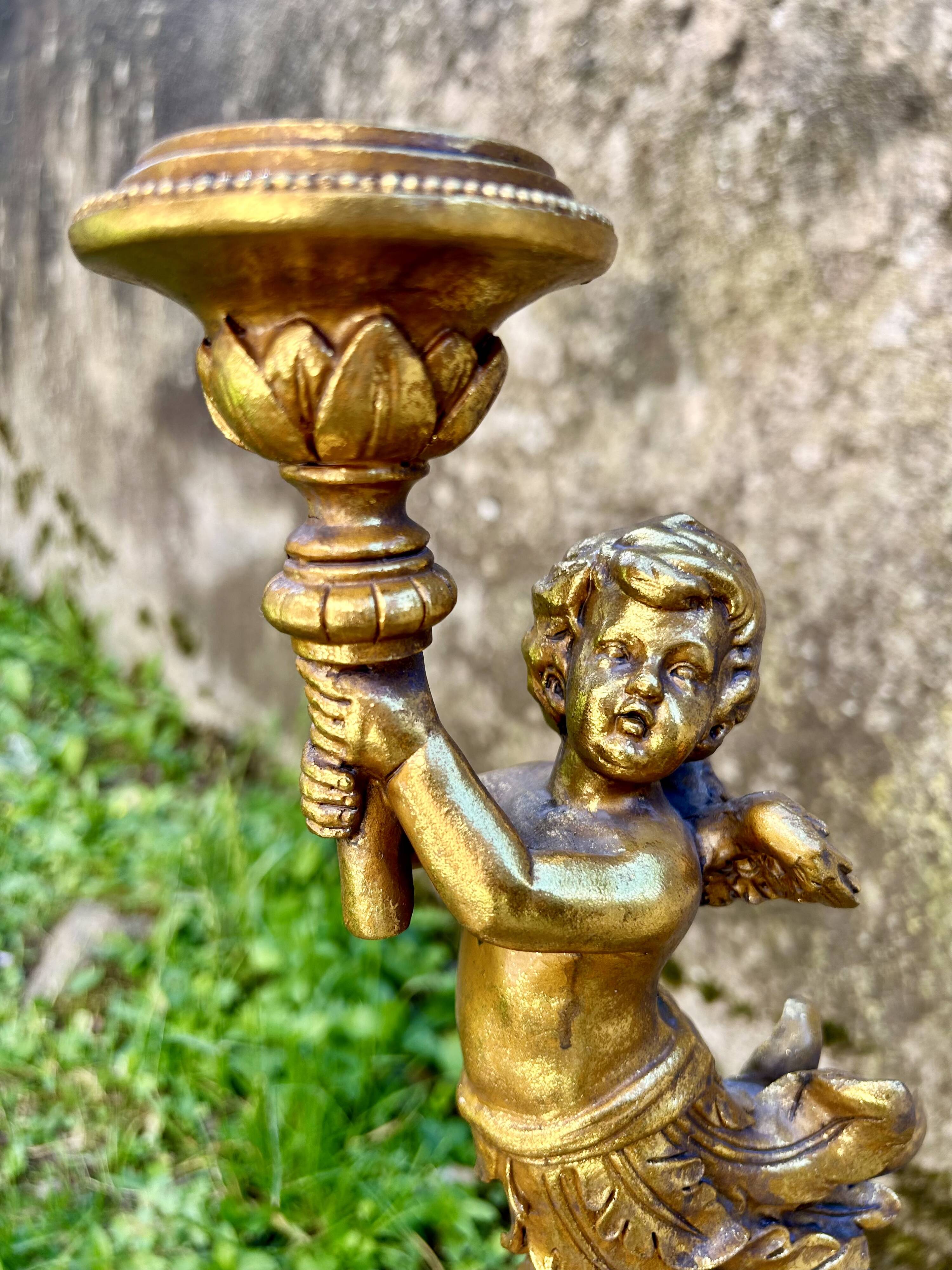 Pair of large candlesticks with cherubs