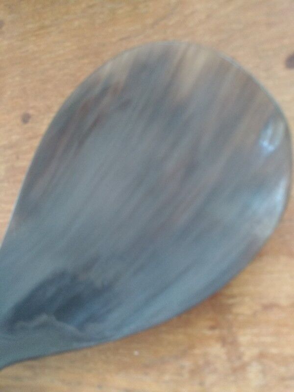 Rice spoon covered with serving in Asian handicraft horn