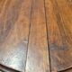 Round dining table with a drop-leaf top in solid walnut, late 19th century.