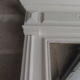 Antique bevelled mirror, frame in pearl grey patinated wood.