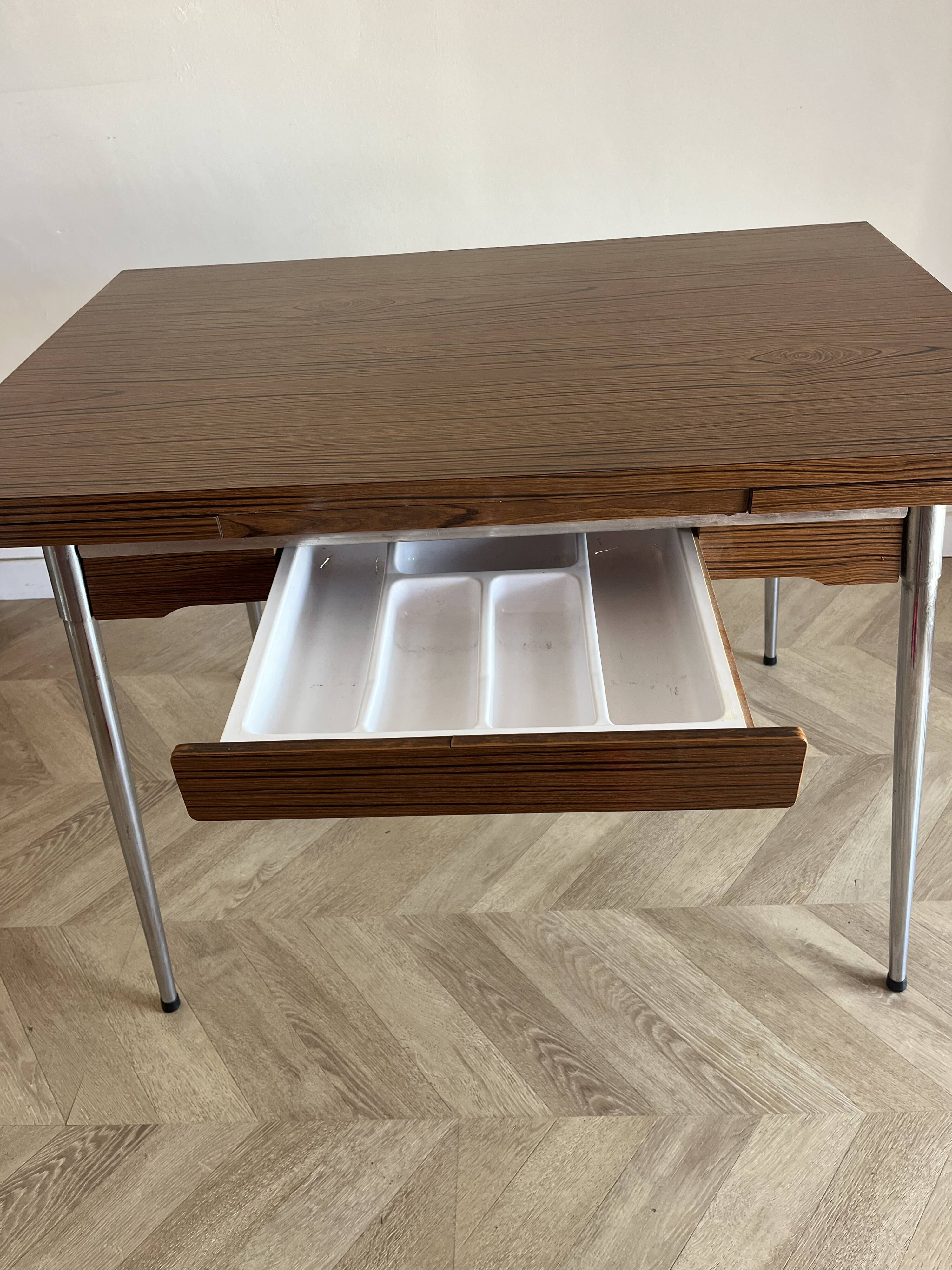 Vintage extendable kitchen table with wood effect Formica and chrome legs.