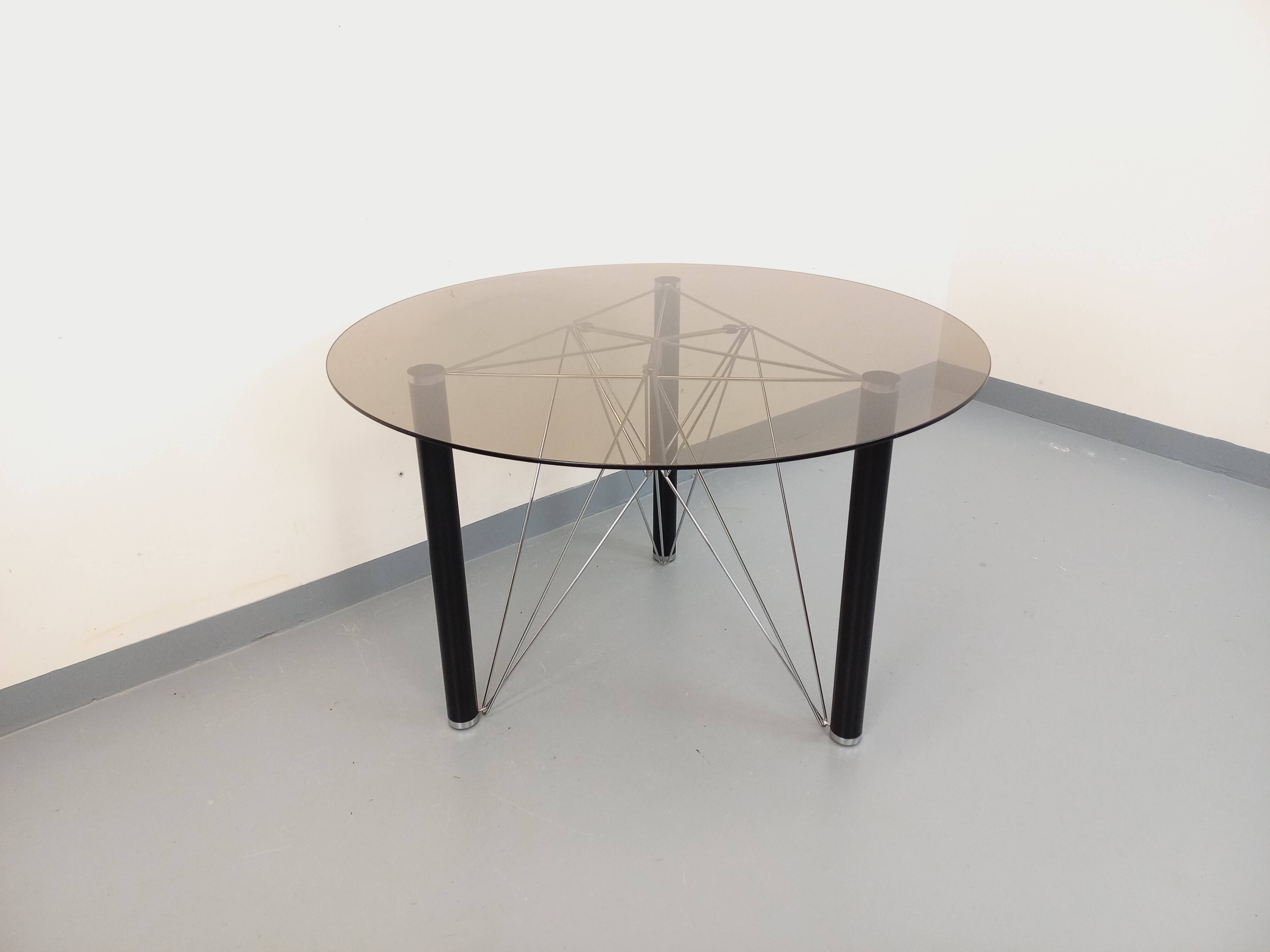 Vintage round dining table in smoked glass, black metal and chrome metal.
