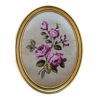 Oval gold frame with pink tapestry