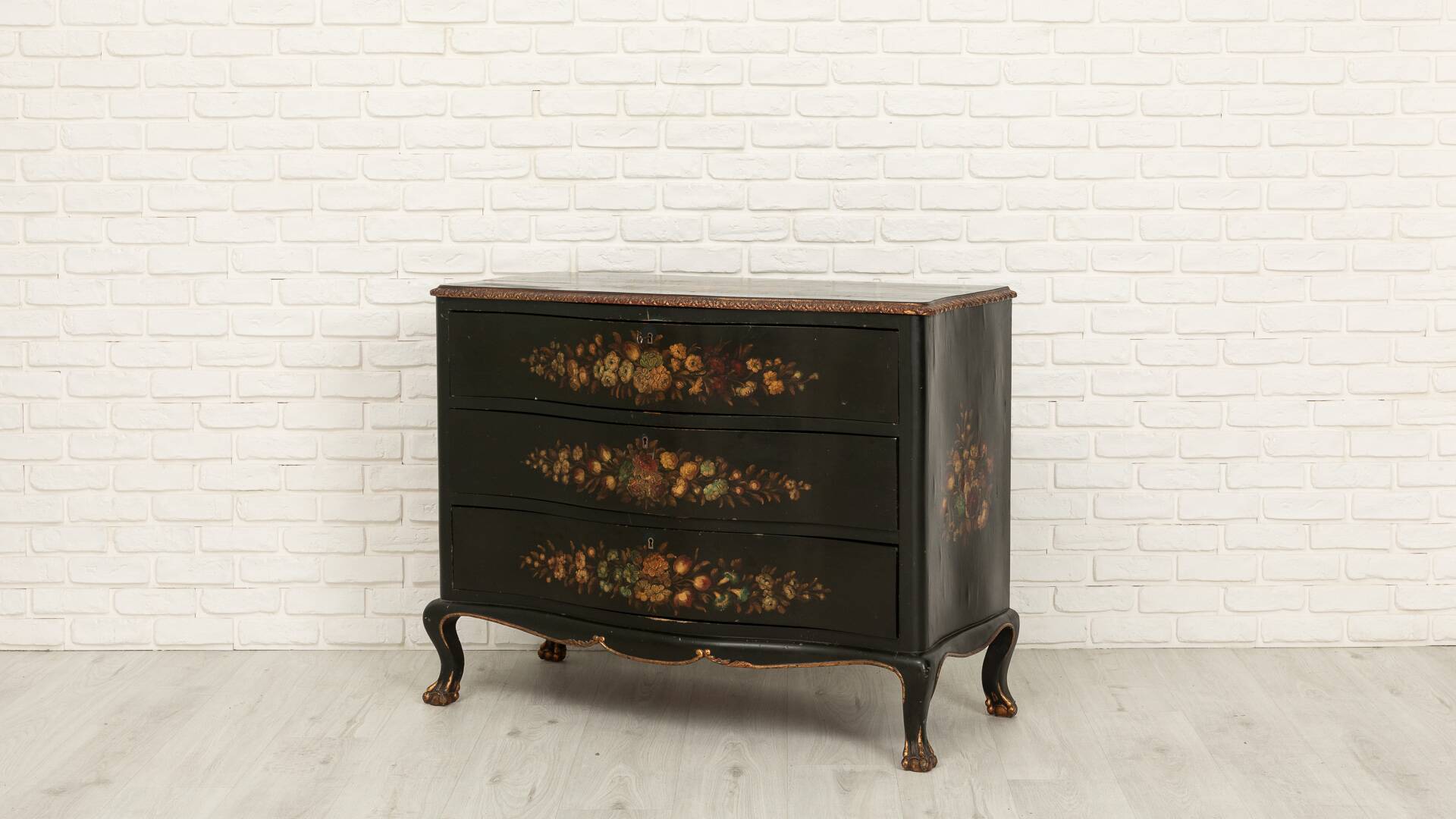 Green chest of drawers with floral decorations