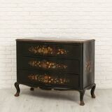 Green chest of drawers with floral decorations