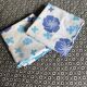 2 vintage cotton pillowcases with blue floral patterns.